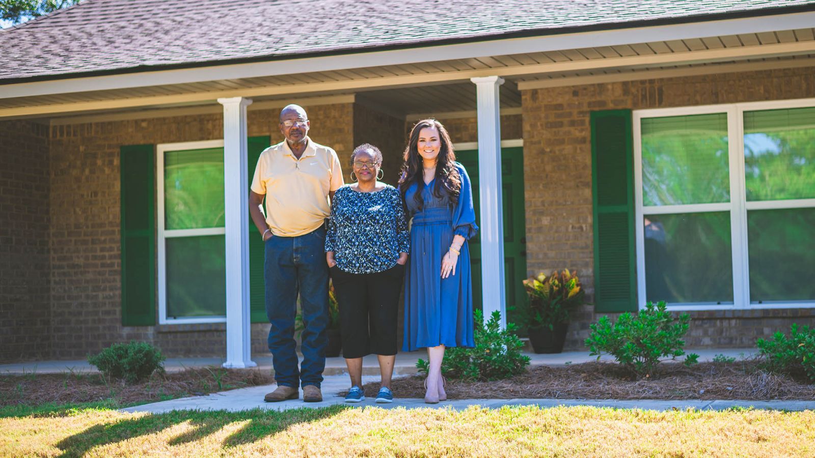 couple in front of new home with lender