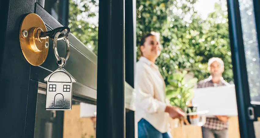 front door with key and new owners